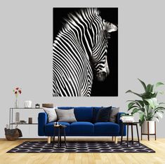 a living room with a blue couch and zebra painting on the wall