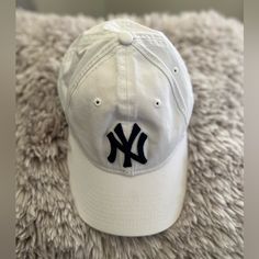 Nwt One Size Fits Most. White With Dark Blue Ny Trendy White Baseball Cap With Short Brim, White Casual Hat With Short Brim, Casual White Hat With Short Brim, Casual White Short Brim Hat, White Snapback Dad Hat One Size, White Cotton Baseball Cap For Beach, Trendy White Hat For Everyday Use, White Cotton Dad Hat For Beach, Trendy White Hat For Everyday