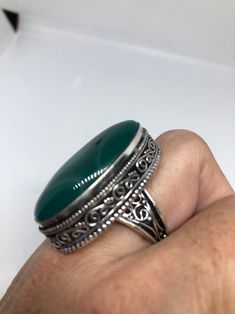 Large green agate Ornate German Silver Vintage ring, does not tarnish Size 9 can be re sized, my jeweler charges a $10 - $15 fee All rings are shipped in a nice gift box. Check out our over a THOUSAND great reviews Engraving is $4 per letter and is not always perfect depending on the piece. It can take a few days if the jeweler is busy. This is payable to Paypal Judithsltd@gmail.com Spiritual Green Open Ring, Bohemian Green Crystal Round Ring, Green Bohemian Crystal Ring, Bohemian Green Emerald Ring As A Gift, Bohemian Green Emerald Ring Gift, Adjustable Green Rings With Large Stone, Adjustable Green Ring With Large Stone, Green Onyx Gemstone Rings As Gift, Green Onyx Rings For Gifts