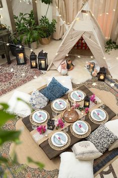 a living room filled with lots of furniture and decor on top of a wooden table