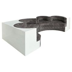 a white and black couch sitting on top of a table