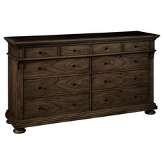 a wooden dresser with many drawers and knobs on the bottom drawer, it is dark brown