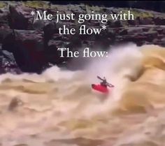 a man in a red kayak riding on top of a wave