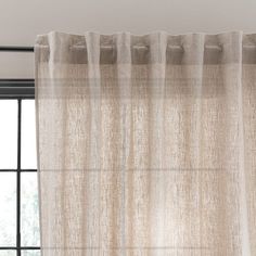 a window with a curtain hanging from it's side