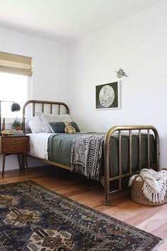 a bedroom with a bed, dresser and rug