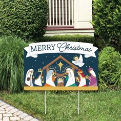 a merry christmas yard sign with nativity scene on it in front of some bushes