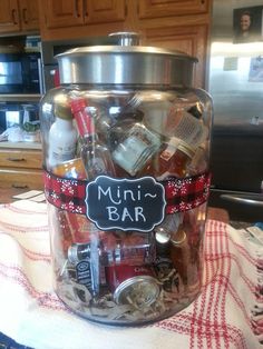 a glass jar filled with assorted items on top of a kitchen counter