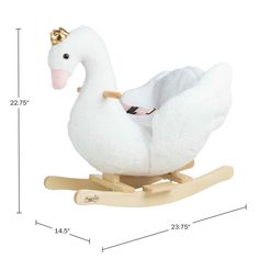 a white stuffed swan sitting on top of a wooden rocking toy with a gold crown