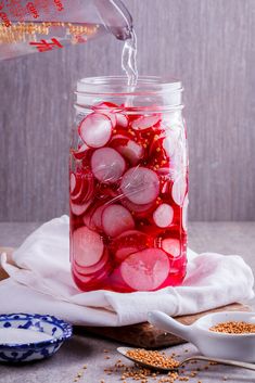 a mason jar filled with pickled red onions