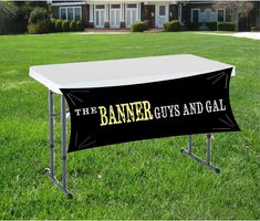 the banner guts and gal sign on a table in front of a house with grass