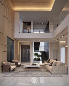 a living room with couches, tables and stairs in the center is lit by recessed lights