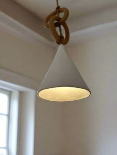 a light hanging from a ceiling in a room