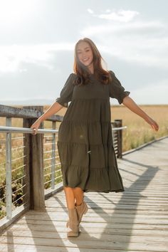 This midi-length floral dress is covered in tiered details, flow and fabric that is equal part durable and lightweight. The puffy sleeves have an elastic at the bottom to create a ruffle effect and add extra volume. We are loving neutrals for fall and this dress has it all. This dress was exclusively made for twirling your way to the farmers market. *Fabric has no stretch. Size up if in between sizes. Otherwise true to size.* Material Content: 94% Polyester // 6% Spandex Material Pattern: Solid Casual Green Tiered Dress, Brown V-neck Boho Dress For Fall, Spring Bohemian Green V-neck Dress, Green Boho Dress With Floral Print And V-neck, Relaxed Fit Long-sleeved Ruffle Dress, Horseshoe Necklace Gold, Pear Body Shape, Swim Shop, Striped Socks