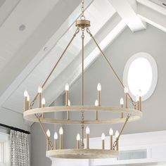 a chandelier hanging from the ceiling in a room with white walls and windows