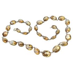 This gorgeous necklace holds 29 stones all set in simple settings. The stones start with larger at the centre and get smaller towards the clasp. modelled in 9carat gold. Length:44.5cm Stone Dimensions: 10x14mm - 7x9mm Weight: 21.6g Classic Formal Necklace With Stones, Classic Formal Necklaces With Stones, Classic Oval Jeweled Necklace, Classic Oval Jeweled Necklaces, Classic Oval Jewel Necklace, Classic Faceted Necklace For Formal Occasions, Classic Gold Citrine Necklaces, Formal Citrine Necklace With Oval Shape, Oval Citrine Necklace For Formal Occasions