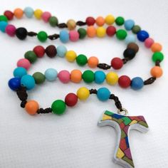 Beautiful Rosary created especially for the little ones, to teach them to pray the rosary in joy and in the family. Hand-molded grains in polymer clay, cross Tau hand-painted Visit the shop to see all the creations of the rosaries or contact me with a message to customize it as you like:  progettomandivina.etsy.com Handmade Multicolor Rosary As A Gift, Multicolor Rosary With 8mm Beads As Gift, Handmade Multicolor Rosary As Gift, Multicolor Handmade Rosary As Gift, Multicolor 8mm Beads Rosary As Gift, Multicolor Beaded Rosary As Gift, Polymer Clay Cross, Clay Cross, Pray The Rosary