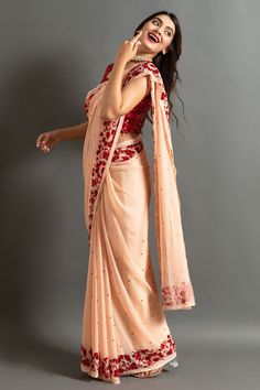 Peach saree highlighted by red sequin embroidered floral motifs on border and sequin buttis. Comes with contrast blouse.
Components: 2
Pattern: Embroidered
Type Of Work: Sequin
Neckline: Round
Sleeve Type: Sleeveless
Fabric: Chiffon
Color: Peach
Other Details: 
Sequin border
Closure: Blouse: Side zip
Occasion: Mehendi and Haldi,Sangeet - Aza Fashions Peach Saree, Contrast Blouse, Red Sequin, Blouse Online, Fashion App, Aza Fashion, Blouses For Women, India, Types Of Sleeves