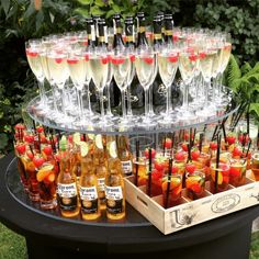 a table topped with lots of wine glasses and bottles filled with different types of drinks