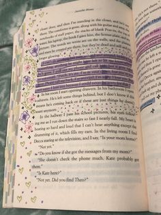 an open book with some writing on the page and colorful lines in it, sitting on a table