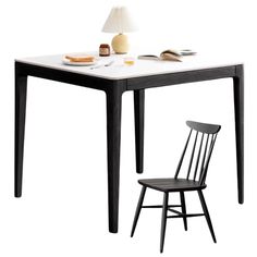 a black and white table with a chair next to it on a white background,