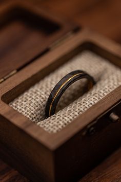 a wooden box with a wedding ring in it