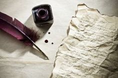 an old paper with writing and a quill on it next to a bottle of ink