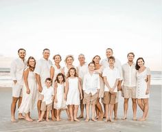 a family poses for a photo on the beach