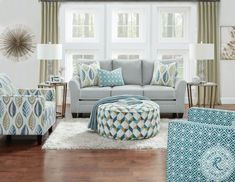 a living room filled with furniture and pillows on top of a white carpeted floor