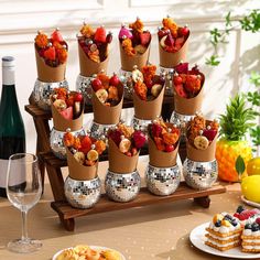 a table topped with lots of cups filled with food