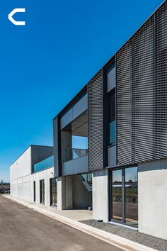 the building has many windows on it and is made out of metal slatted