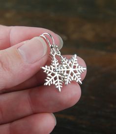 Sterling silver snowflake charm earrings, snowflake, winter, snow, snowflake earrings, silver earrings, holiday, Christmas Sterling silver snowflake charms are suspended from sterling silver ear wires. A perfect accessory for the holidays. The earrings measure 1.30 inches (33mm) in length. Your purchase will arrive in a jewelry box ready for gift giving or as a gift for yourself! Enter my shop here: jersey608jewelry.etsy.com Thanks for looking! Raquel Silver Snowflake Sterling Silver Jewelry, Silver Sterling Snowflake Jewelry, Sterling Silver Snowflake Jewelry, Snowflake Shaped Jewelry With Matching Earrings For Gifts, Sterling Silver Snowflake Jewelry For Winter, Handmade Sterling Silver Christmas Earrings, Nickel-free Sterling Silver Christmas Earrings, Handmade Snowflake Earrings As Gift, Nickel Free Sterling Silver Christmas Jewelry