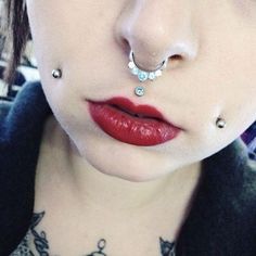 a woman with piercings on her nose and lip