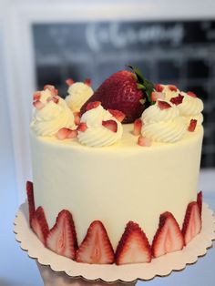 a close up of a cake with strawberries on top