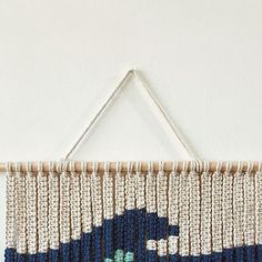 a blue and white wall hanging on the side of a wall