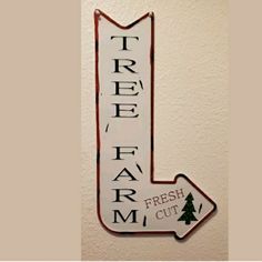 a sign that says tree farm and the word fresh cut is painted in black on a white wall