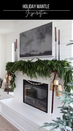 a fireplace decorated for christmas with greenery and bells hanging from the mantel above it