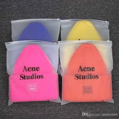 three beanies with acne studios written on them