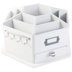 a white box with four compartments on the bottom and one drawer at the top that is open