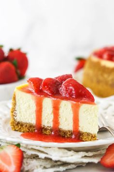 a slice of cheesecake with strawberries on top and another piece in the background