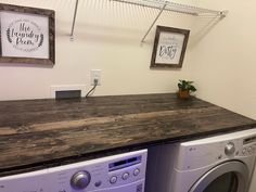 a washer and dryer sitting next to each other in a room with pictures on the wall