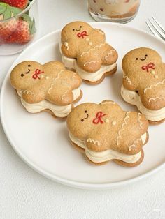 some cookies are on a white plate with strawberries in the background