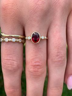 a woman's hand with a ring on it and a stone in the middle