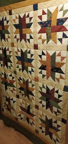 an old quilt is hanging on the wall