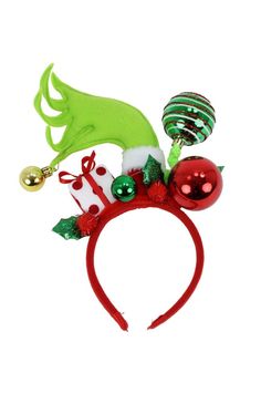 a red headband with green and white ornaments on it's side, along with bells