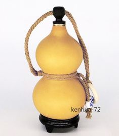 a yellow vase with a rope around it