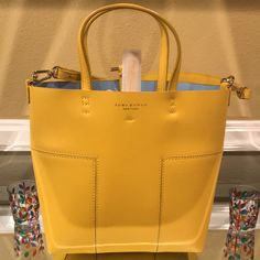 Nwot Yellow Tory Burch Tote. This Is A 10x11 Tote Bag With A Small Removable Wallet. It Comes With Removable Straps To Use As A Crossbody Bag. No Damages Or Stains On It. The Original Tory Burch Dust Bag Is Included. Designer Yellow Bag With Top Carry Handle, Luxury Yellow Shopping Bag, Luxury Yellow Shoulder Bag For Shopping, Designer Yellow Leather Bags, Yellow Crossbody Bag With Top Carry Handle, Designer Yellow Bags For Everyday Use, Designer Yellow Top Handle Shoulder Bag, Yellow Shopping Bag With Detachable Handle, Designer Yellow Shoulder Bag With Detachable Handle