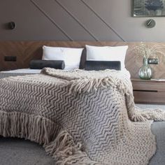 a bedroom with a large bed covered in a blanket