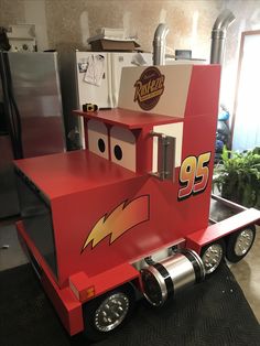 a cardboard race car made to look like a truck with lightning bolt painted on the side