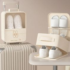 two suitcases with shoes in them sitting next to each other on top of a table