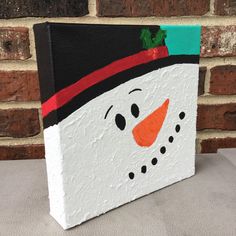 a painted snowman on a brick wall